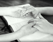 Praying holding hands